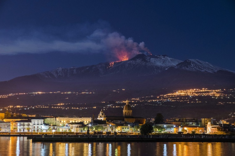 Image: Mount Etna spews lava as the Sicilian town of Riposto