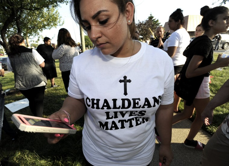 Image: A woman wears a Chaldeans Lives Matter T-shirt