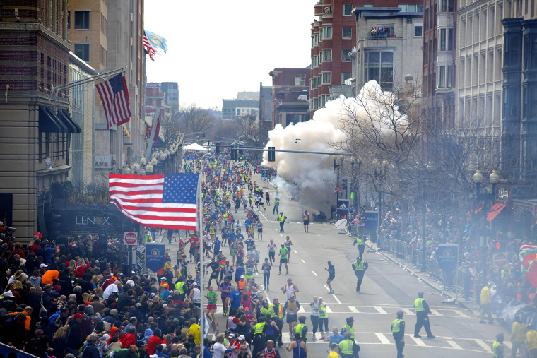 A bomb explodes in the crowd as runners cross the finish line during the 117th Boston Marathon