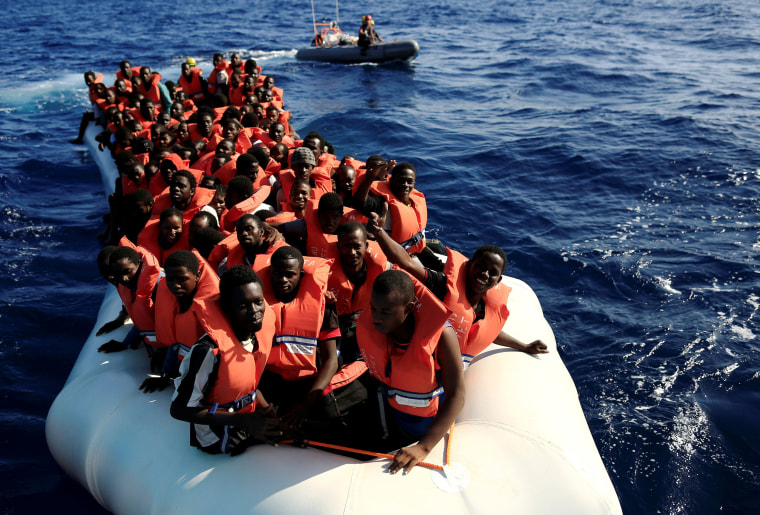 Image: An overcrowded dinghy with migrants from different African countries is followed by members of the German NGO Jugend Rettet as they approach the Iuventa