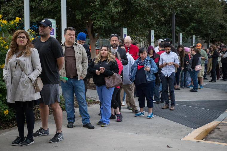 People wait at a polling place in Houston on Monday, the first day of early voting in Texas.