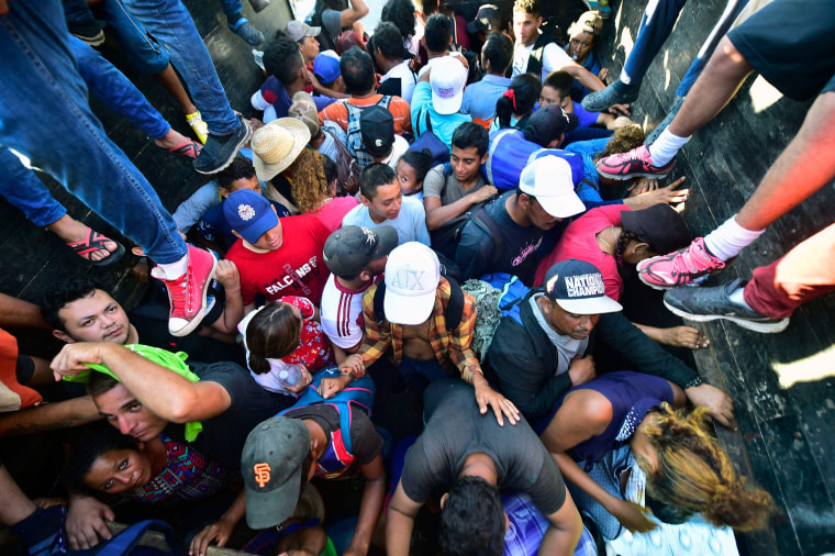 Migrants board a truck in Metapa on their way to Tapachula, Mexico, on Monday.