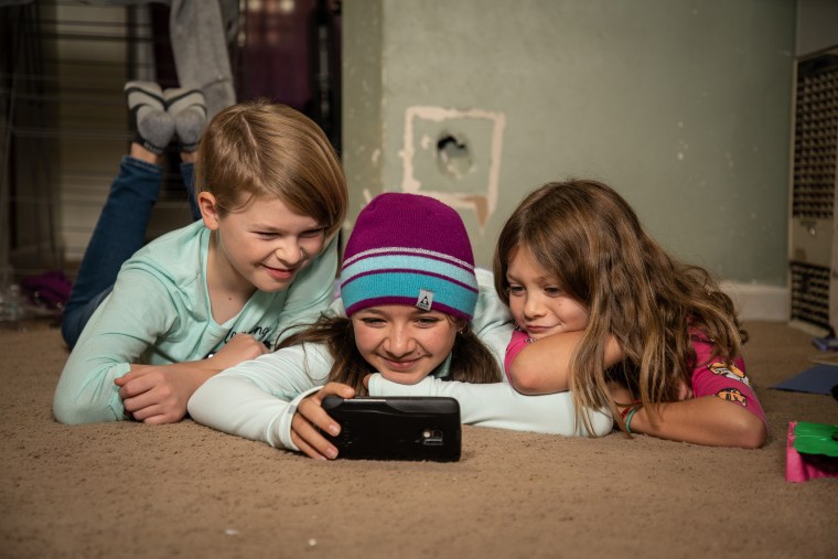 Ori Turner, left, plays with their sisters at home.