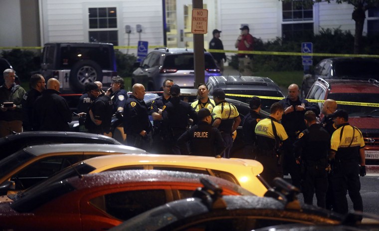 Image: Police gather near the South Medical Tower on the University of Utah campus during a search for a man they say shot and killed a University of Utah student