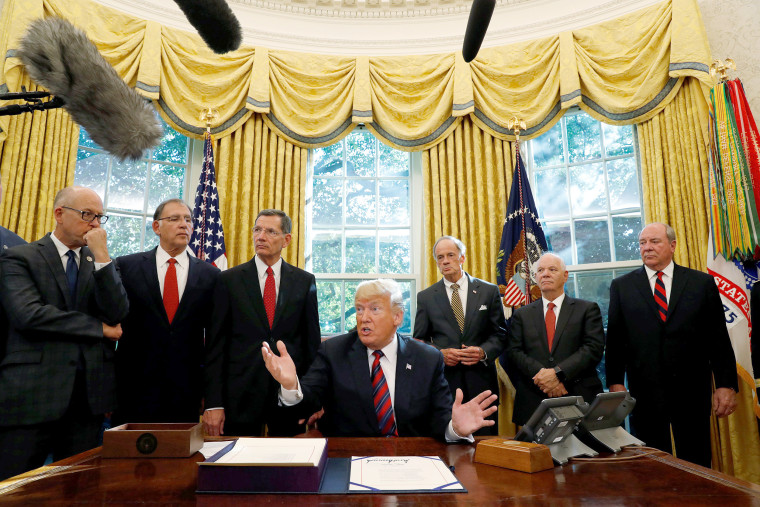Image: U.S. President Trump talks to reporters during bill signing ceremony at the White House in Washington