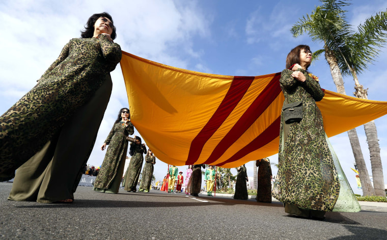 Participants carry the former South Vietnam flag during the Tet parade in the Little Saigon area of Westminster, California on Feb. 4, 2017.