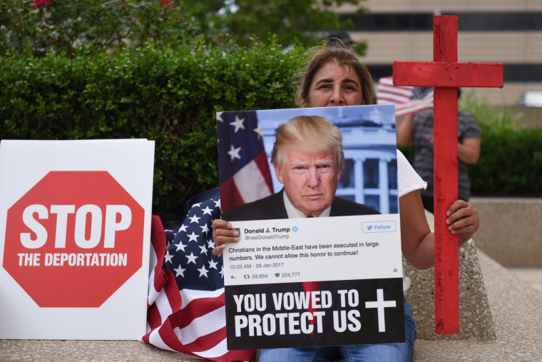 Amal Hana, of Warren, Mich., holds a photo of Donald Trump on June 16, 2017, outside the Patrick V. McNamara Federal Building during a protest in Detroit. Hana joined hundreds others to protest the recent ICE raids in which more than 100 Iraqi nationals in Metro Detroit were detained.