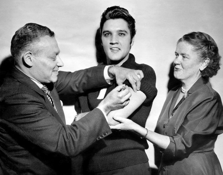 Elvis Presley receiving a polio vaccination from Dr. Leona B