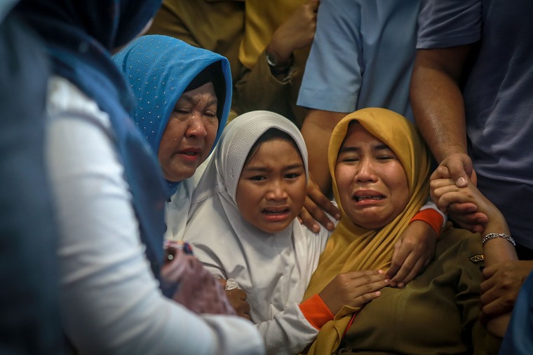 Image: Family members mourn at Pangkal Pinang airport