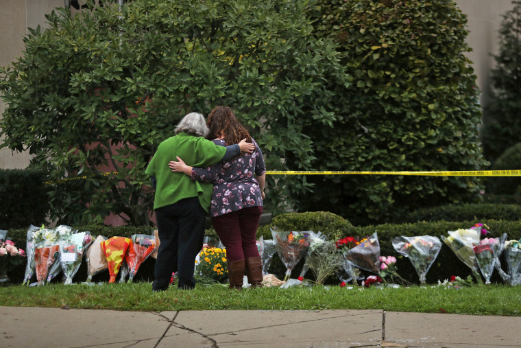 Image: People visit an impromptu memorial at the Tree of Life synagogue following Saturday's shooting at the synagogue in Pittsburgh Pennsylvania