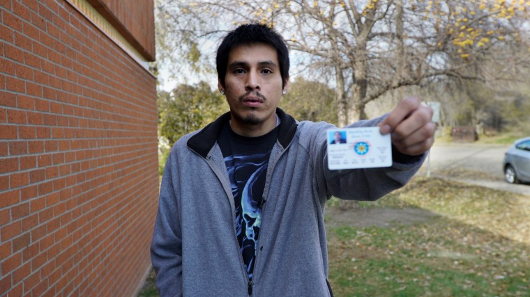 Jeffery White Twin, 27, shows his ID outside the Sioux County offices at the Standing Rock Reservation.