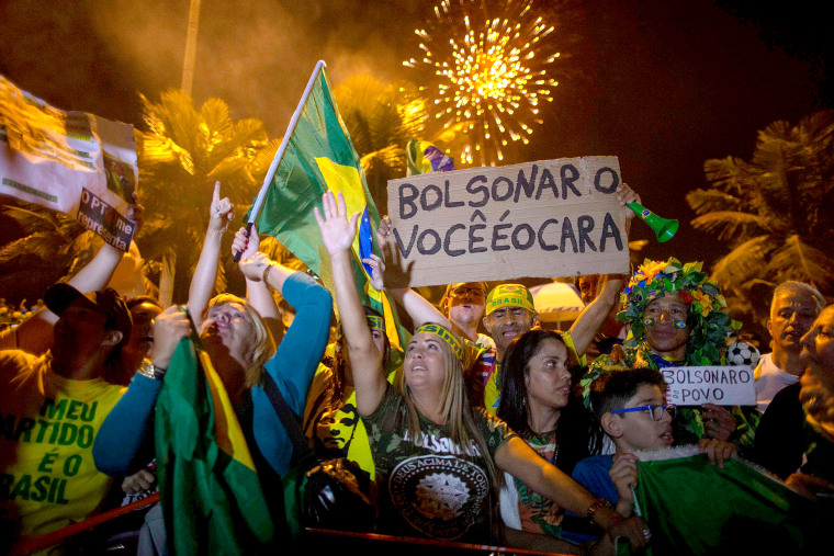 Image: Supporters of far-right presidential candidate Jair Bolsonaro, celebrate in front of his house in Rio de Janeiro, after he won Brazil's presidential election, on Oct. 28, 2018