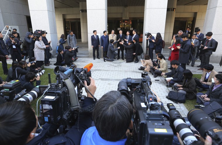 Image: Oh Seung-hun, top center, speaks to the media after the verdict
