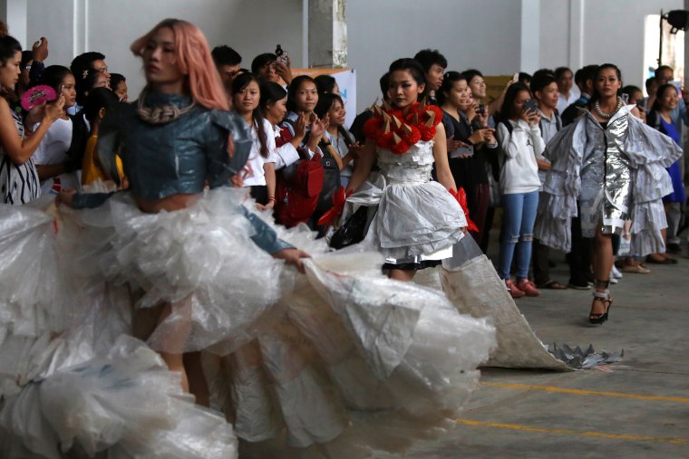 Image: Models wear clothes made out of recycled materials during a show organised by LGBT fashion designers to battles discrimination in Phnom Penh