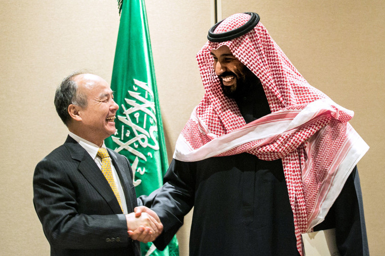 Image: Masayoshi Son, chairman and chief executive officer of SoftBank Group Corp., left, shakes hands with Mohammed bin Salman, Saudi Arabia's crown prince, after signing an agreement in New York