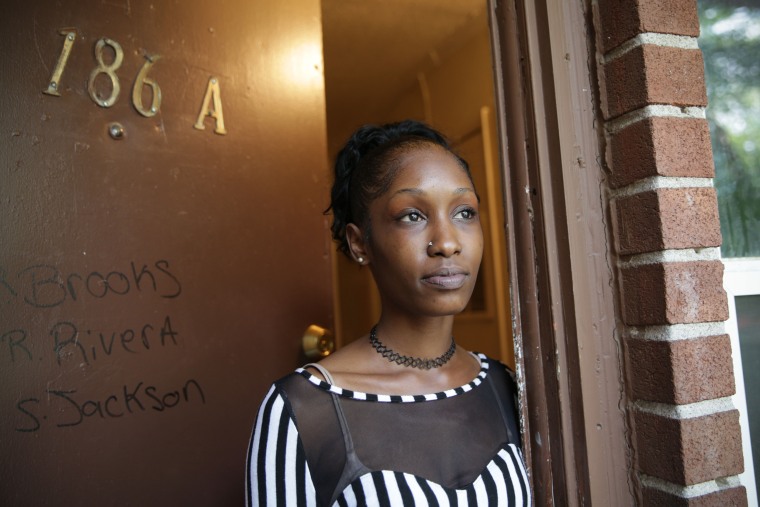 Rondesha Brooks stands in the doorway of her Infill apartment. 