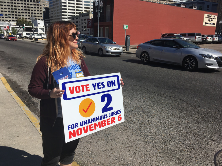 New Orleans resident Molly Ezell holds a sign on Oct. 29 in New Orleans promoting a Louisiana constitutional amendment that would require unanimous 12-member jury verdicts in serious felony cases.