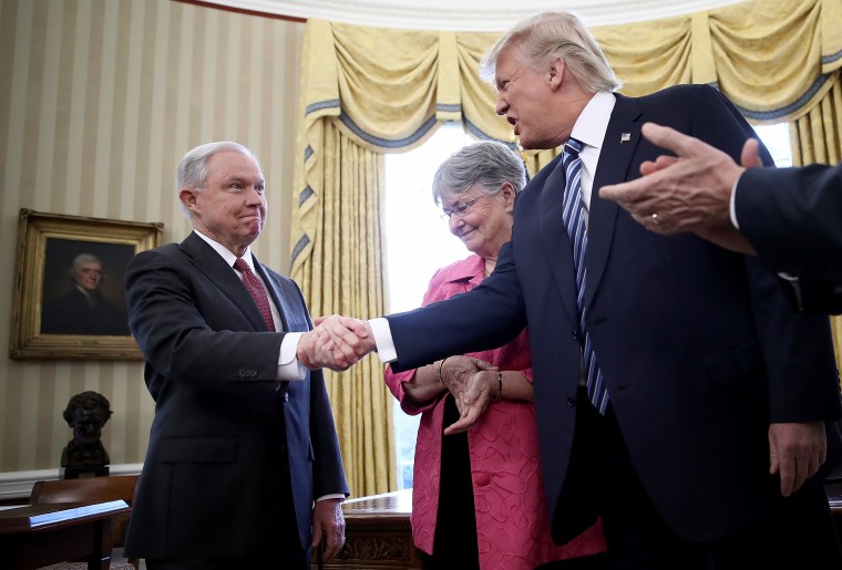 Trump shakes Jeff Sessions' hand after Sessions was sworn in as U.S. Attorney General