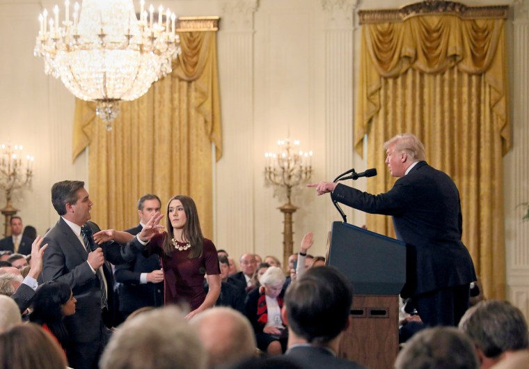 Image: A White House staff member reaches for the microphone held by CNN's Jim Acosta as he questions U.S. President Donald Trump during a news conference in Washington