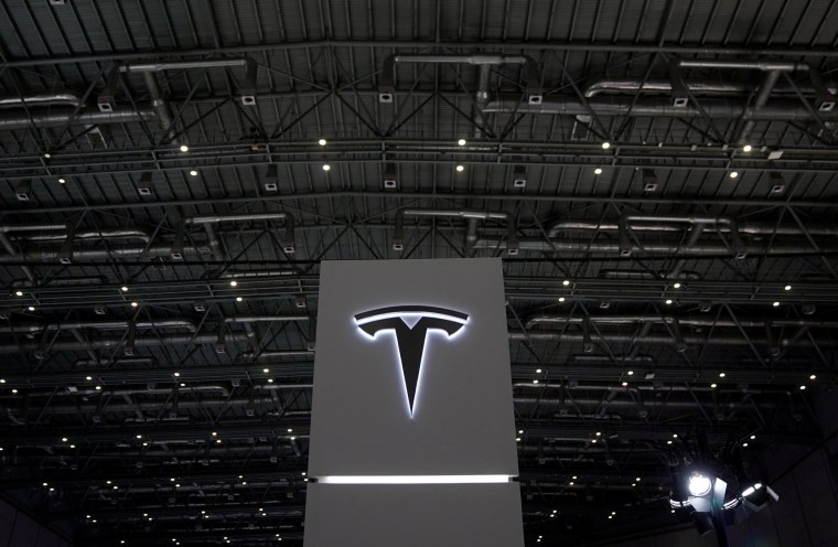 Image: A Tesla sign is seen during the China International Import Expo (CIIE), at the National Exhibition and Convention Center in Shanghai