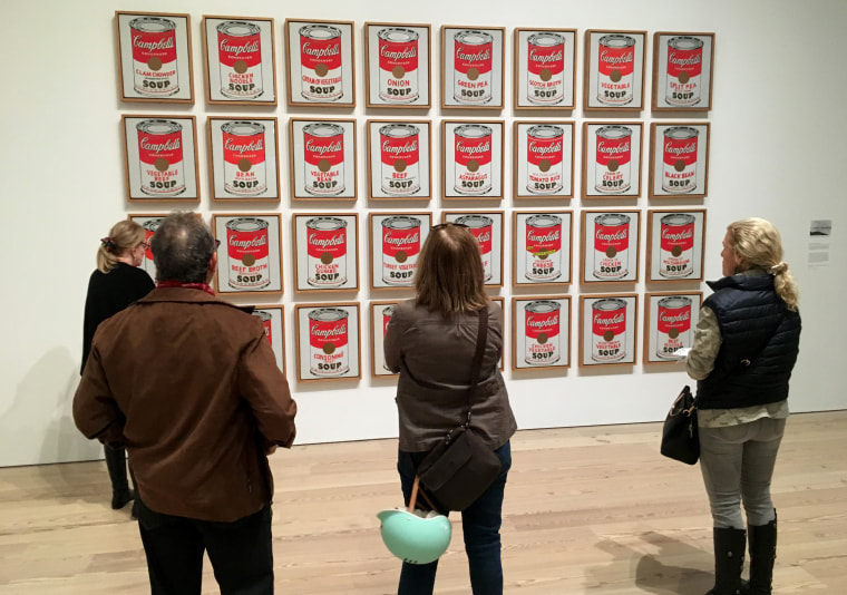 Visitors view Andy Warhol's \"Campbell's Soup Cans\" at a new exhibition at the Whitney Museum of American Art in New York.