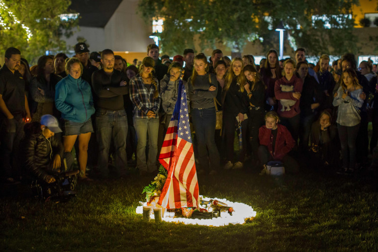 People gather during a vigil for the victims of a shooting in Thousand Oaks, California