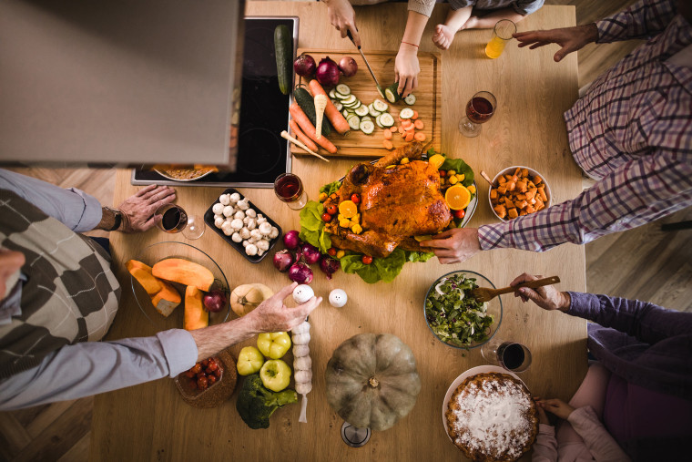 Above view of extended family making Thanksgiving dinner.