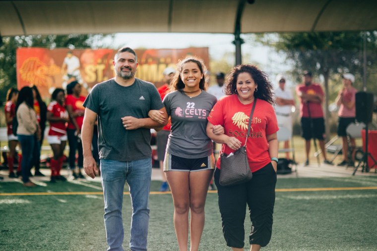 Jordan Thompson with her parents, Martin and Jana Thompson, at a soccer event.