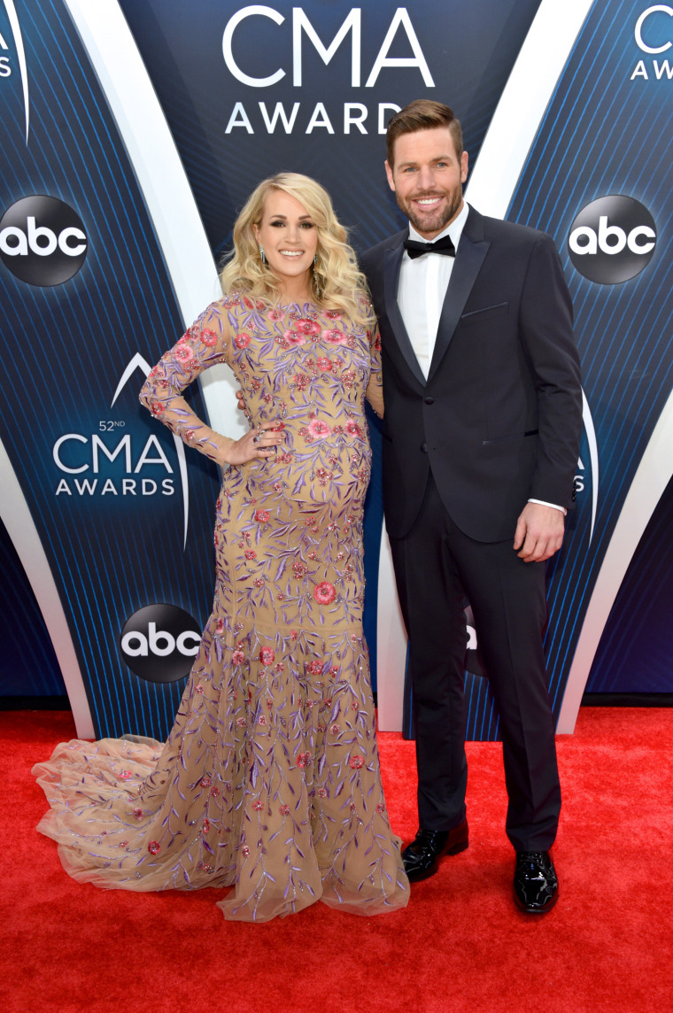 Carrie Underwood is joined by husband Mike Fisher on the red carpet at the  CMA Awards, where she will be participating in three separate