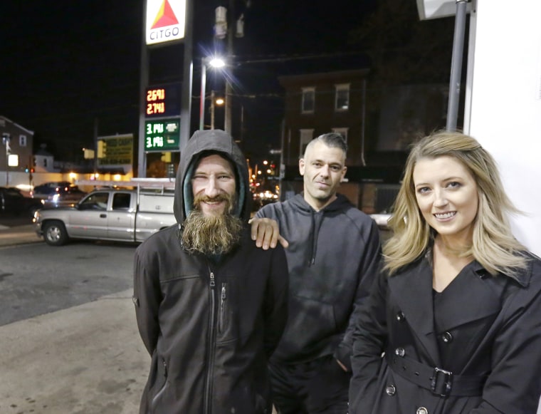 Johnny Bobbitt Jr., left, Kate McClure, right, and McClure's boyfriend Mark D'Amico