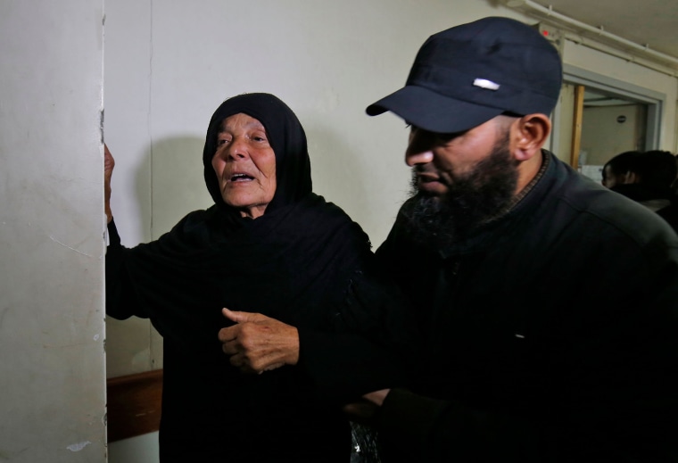 Image: The mother of Nour Baraka, a commander for Hamas' armed wing, reacts at the morgue where his body was transported