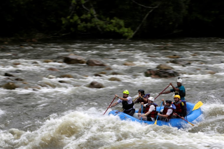 Image: A group of the press and government representatives practice rafting guided by ex-FARC rebels in Miravalle