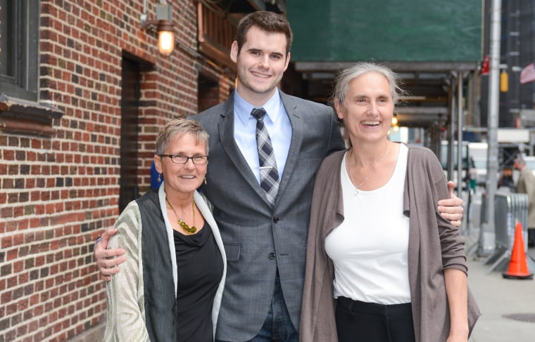 Zach Wahls poses for a photo with his moms, Jacqueline Reger, left, and Terry Wahls, right, in New York in 2012.