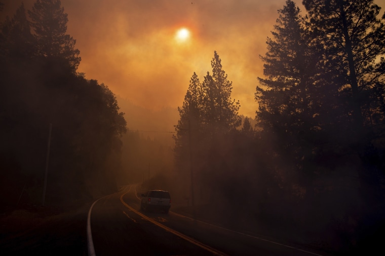 A vehicle drives through smoke from a wildfire near Pulga, California on Nov. 11, 2018.