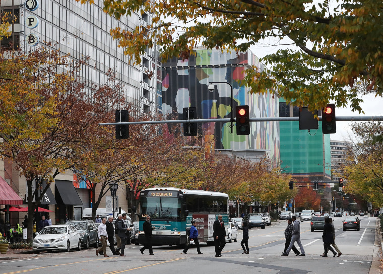 Pedrestrians cross Crystal Drive near the 1851 S. Bell Street building in the Crystal City area of Arlington, Virginia, on Nov. 13, 2018.