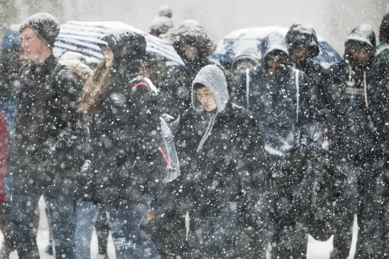 People walk on Independence Mall during a snow storm in Philadelphia on Nov. 15, 2018.