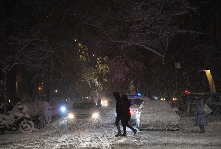 Pedestrians walk through snow in Manhattan on Nov. 15, 2018 in New York.
