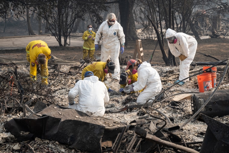 Rescue teams search for human remains in the rubble of the Camp Fire in Paradise, California on Friday. 