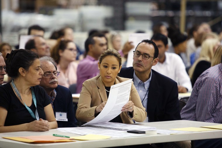 Volunteers look at ballots during a hand recount at the Supervisor of Elections Service Center in Palm Beach, Florida, on Sunday.