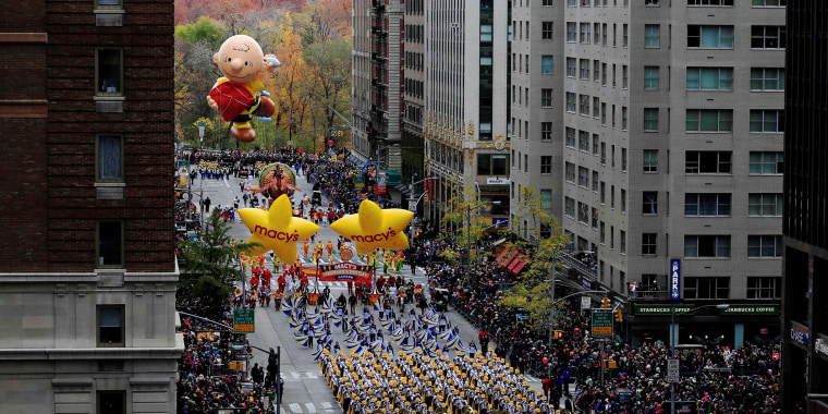 Image: A marching band makes its way down 6th Avenue during the 90th Macy's Thanksgiving Day Parade in the Manhattan borough of New York