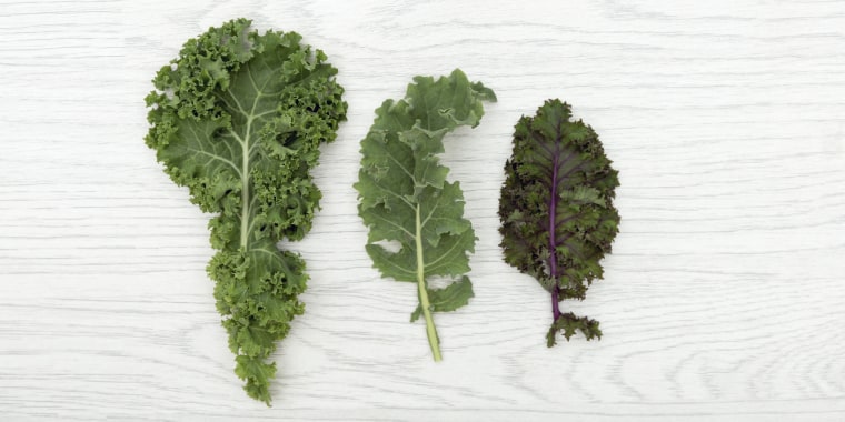Selection of organic kale leaves on table top