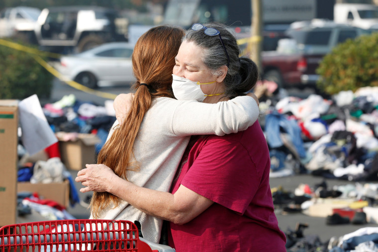 Maddy Mudd, 25, of Oakhurst, hugs Camp Fire evacuee Terri Wolfe, 62, of Paradise, at a donation site for evacuees in Chico