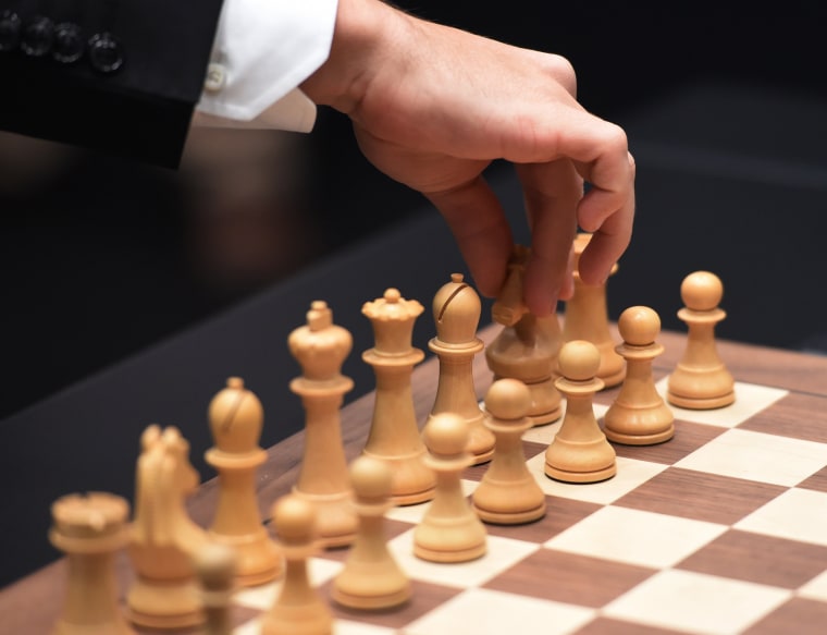 Image: Norway's Magnus Carlsen arranges the board 