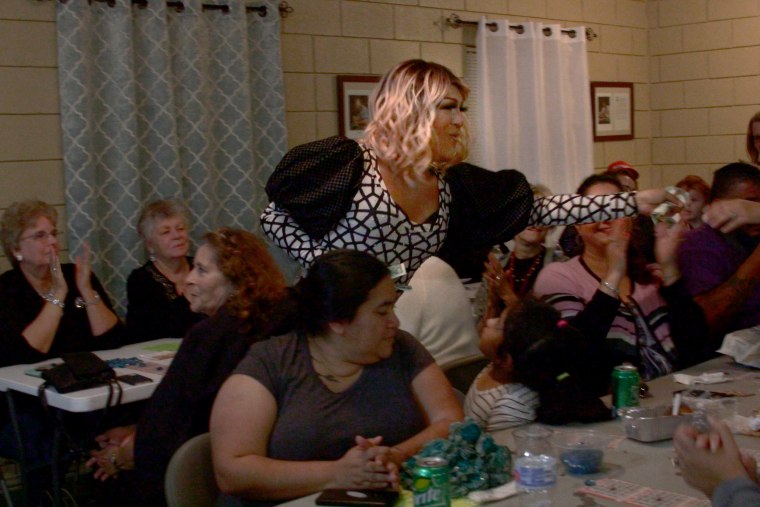 Drag performer Ariel C. Brooks, a member of Drag out H.I.V., takes tips from an enthusiastic crowd.