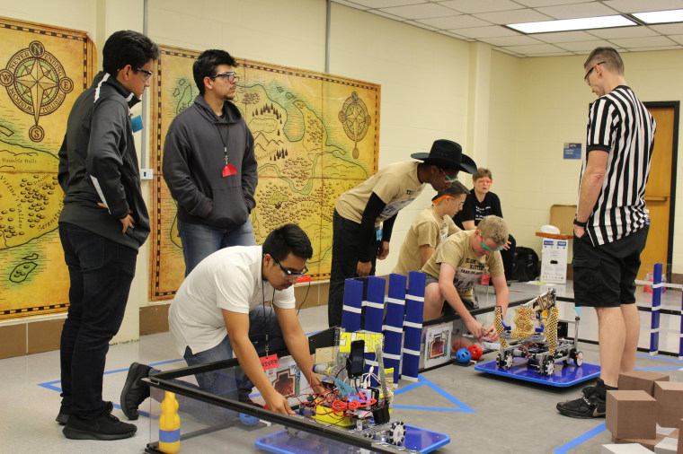 FIRST Tech Challenge Team 10404 sets up their robot for the beginning of a league match.