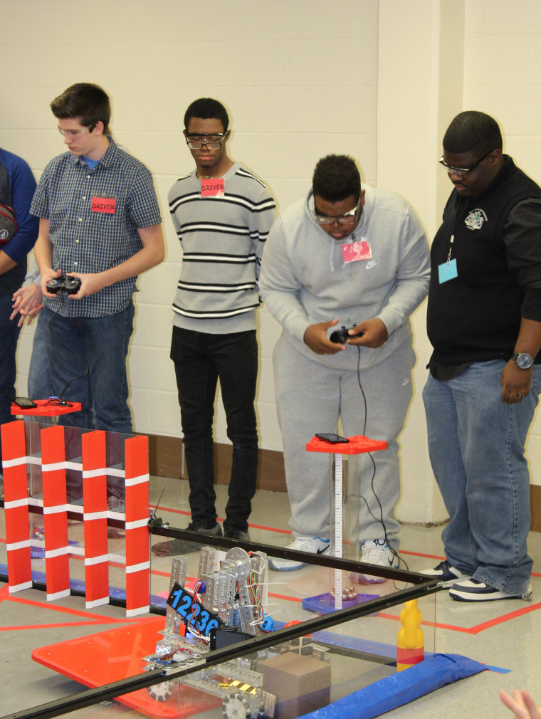 FIRST Tech Challenge Team 12236 climbs on top of the balancing platform at the end of league match.