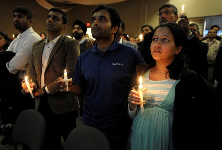 Alok Madasani, who was wounded in a bar shooting that killed Indian engineer Srinivas Kuchibhotla, sings during a candlelight vigil at a conference center in Olathe, Kansas
