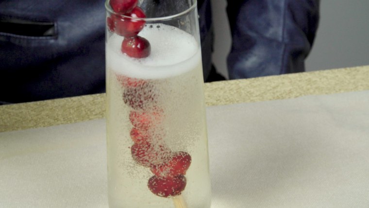 A frozen cranberry stir stick is a festive way to keep champagne cold. 