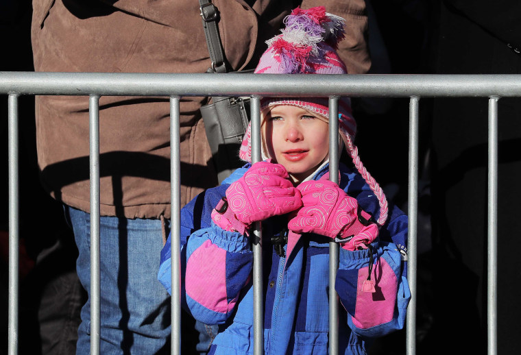 Image: A child watches floats pass from behind a barricade during the Macy's Thanksgiving Day Parade in Manhattan