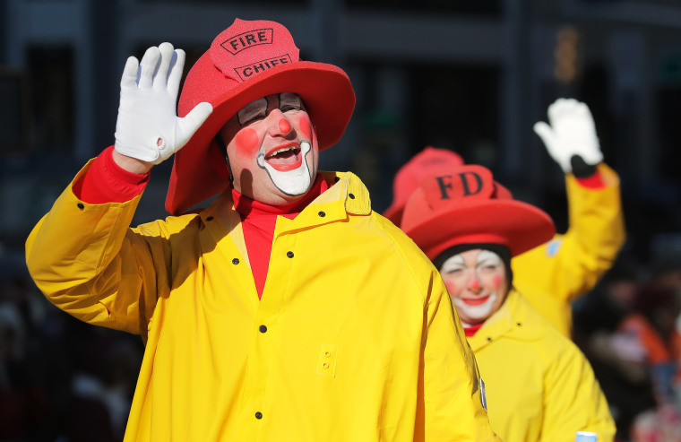 Image: Clowns wave to spectators during the Macy's Thanksgiving Day Parade in Manhattan
